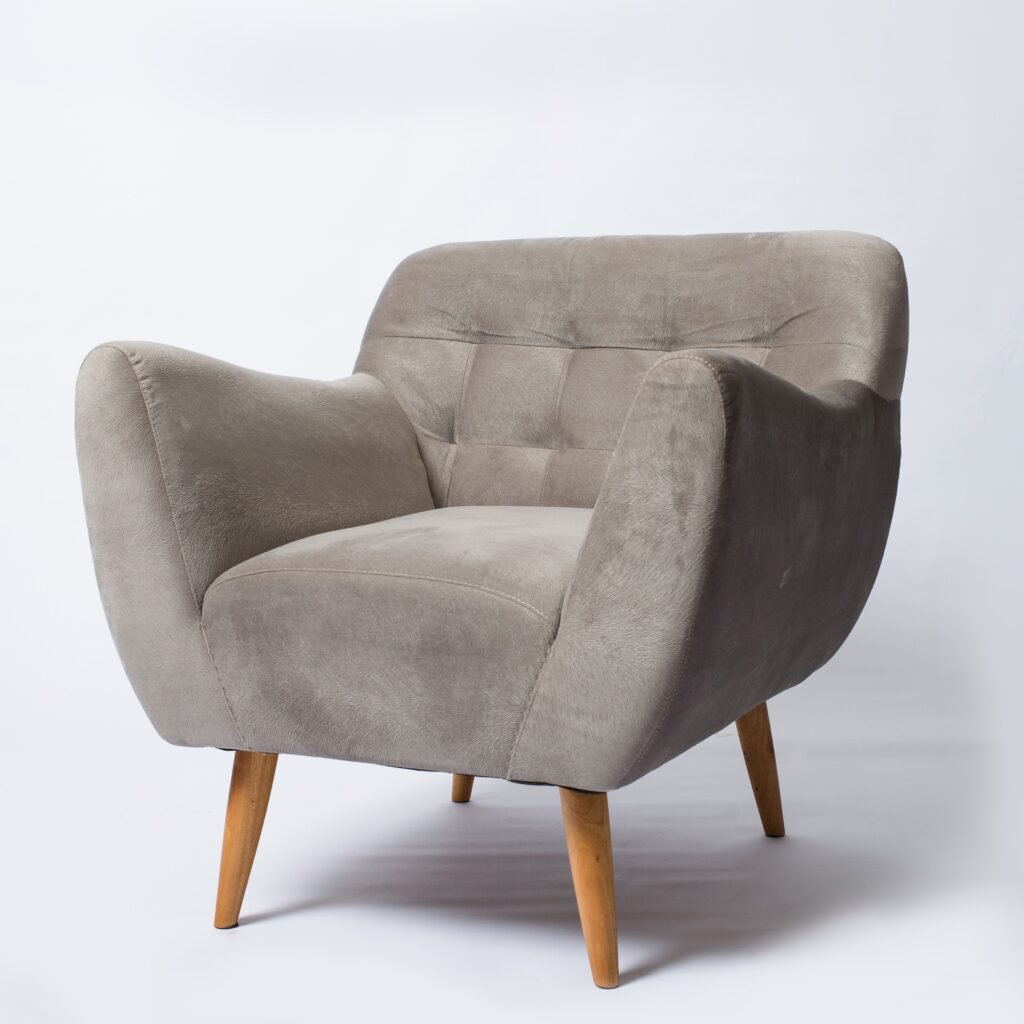 A stylish gray armchair with wooden legs photographed on a white background.
